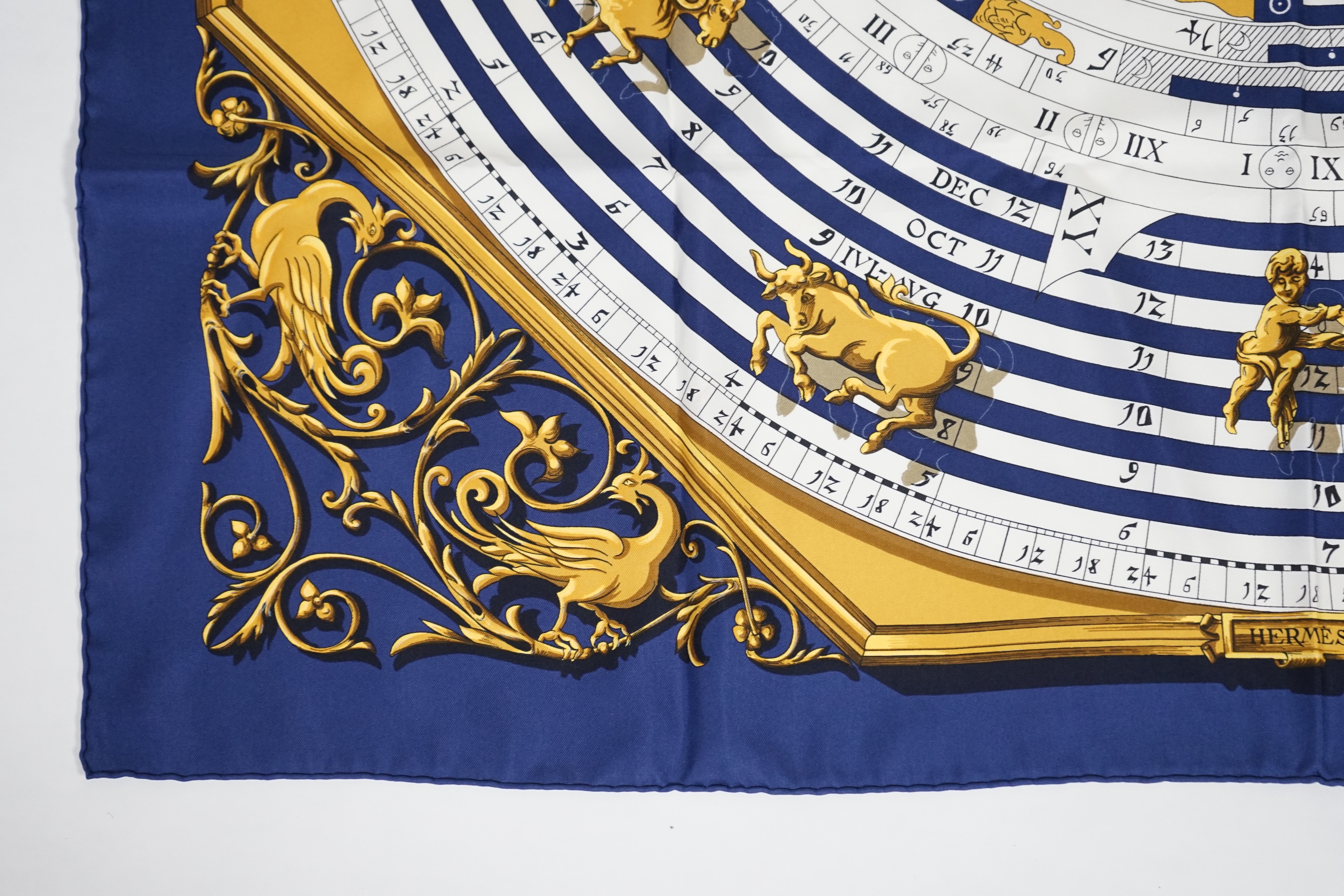 A Hermès Dies et Hore navy silk scarf, 90cm x 90cm